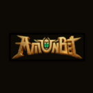 Gold stylized logo with a green gem in the center on a dark background.